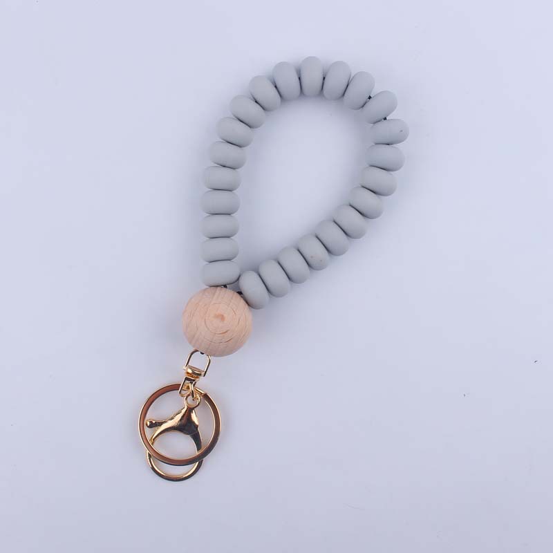 Korean Style Solid Color Wood Silica Gel Metal Beaded Unisex Keychain display picture 7