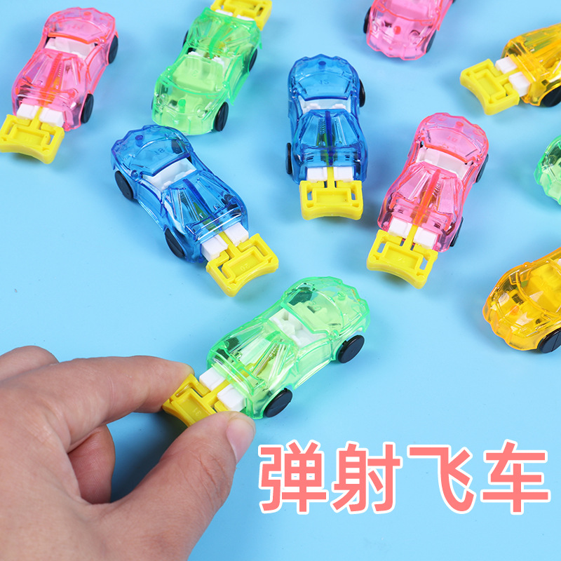 Carreras de velocidad de catapulta Lanzador Carreras de catapulta Carreras de salto inercial Carreras de policía pequeñas Carreras de plástico Niños transfronterizos