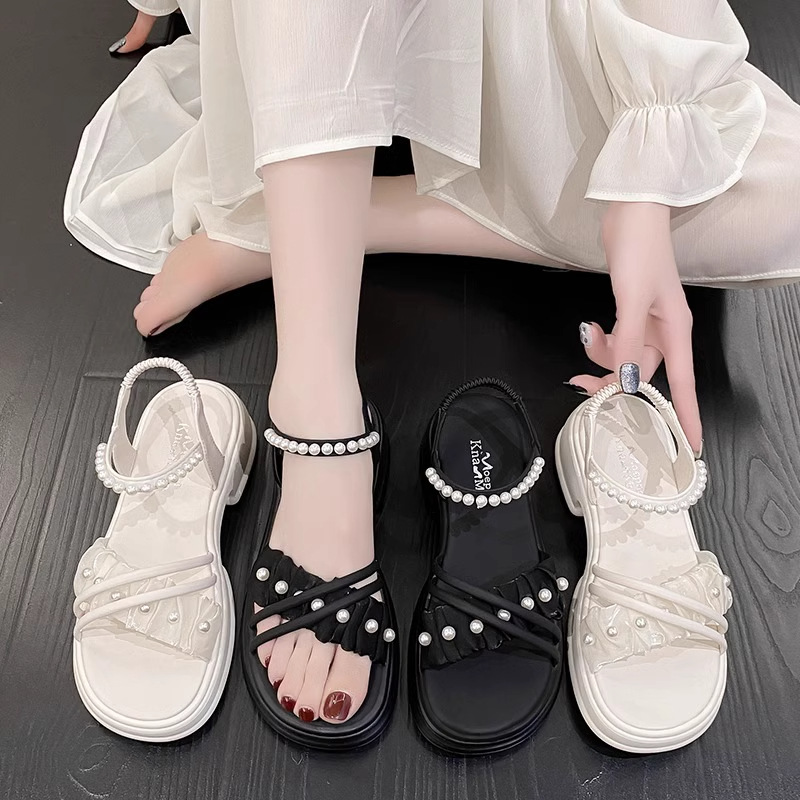 Niñas dulces sandalias de viento plano 2026 verano nueva moda versátil sandalias de playa de perlas zapatos de princesa