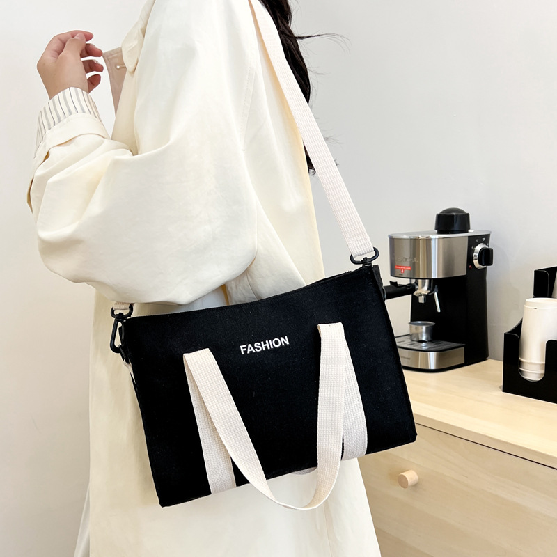 2024 nuevo simple japonés blanco y negro bolso de tela de gran capacidad para estudiantes de clase de viaje mochila de hombro