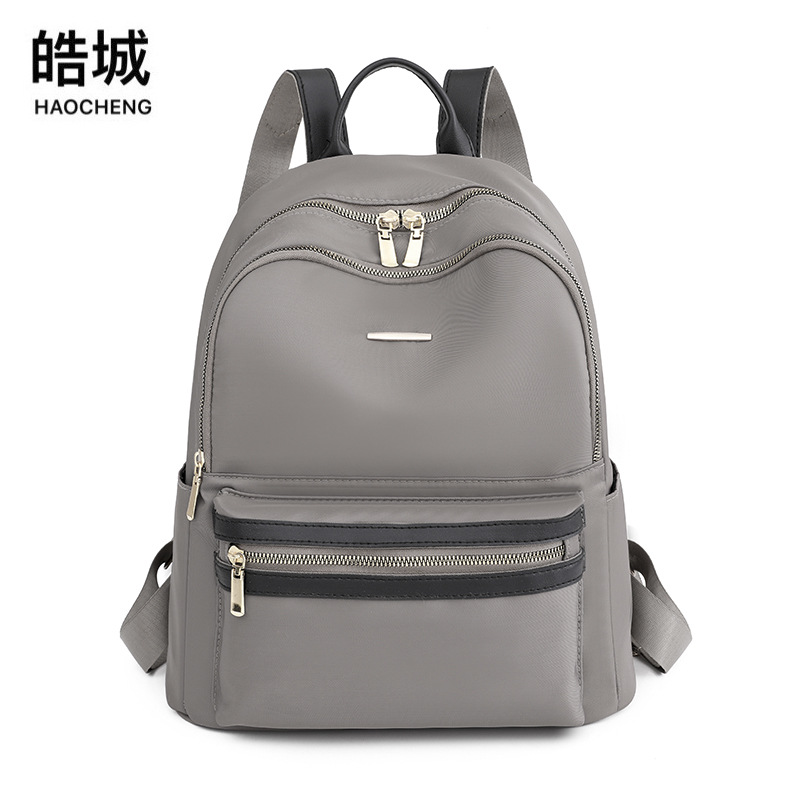 2022 nueva versión coreana de la mochila de nailon para mujer, mochila de cercanías urbana de todo fósforo de moda, mochila escolar ligera al aire libre