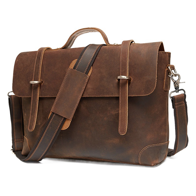 欧米のレトロな本革の男性はブリーフケースを持っています。