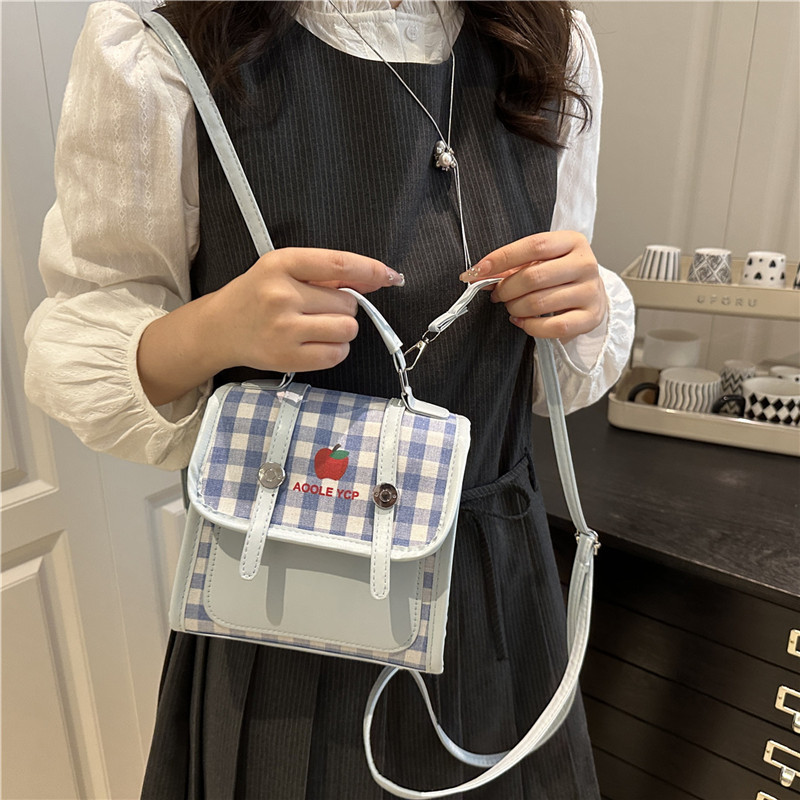 Color contrastante estampado a cuadrícula pequeña y fresca mochila de clase nueva versión coreana de transporte múltiple mochila de moda