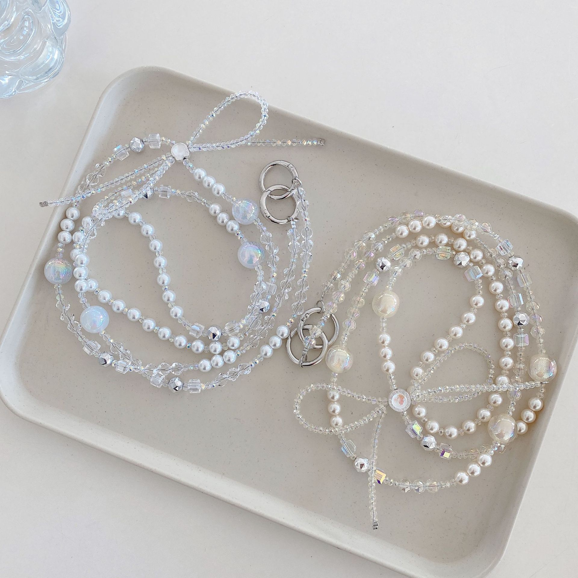 Boutique hecho a mano cadena colgante de alta gama arco fresco de cuatro colores cadena larga cordón de teléfono móvil de moda mensajero largo/colgante