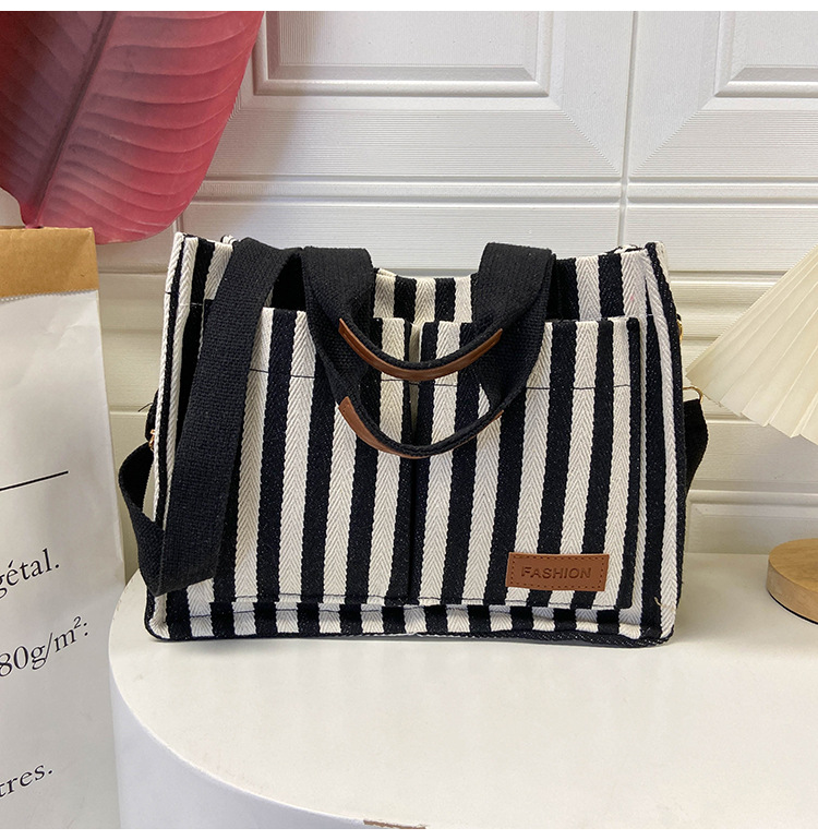 Popular striped canvas 2024 new commuter large capacity casual fashion personalized hand-held crossbody tote women's bag_voghion.com