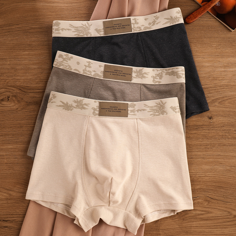 Men's cotton and linen solid-color boxer briefs, breathable, heat-dissipating, comfortable, mid-waist, with a leaf-patterned waistband, and a sporty design