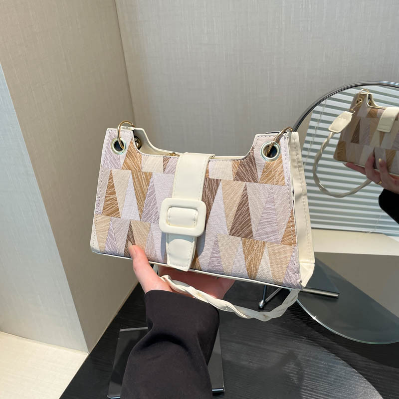 Nicho de diseño geométrico empalme brazalete bolso de hombro para mujeres 2025 primavera nueva textura bolso de hombro