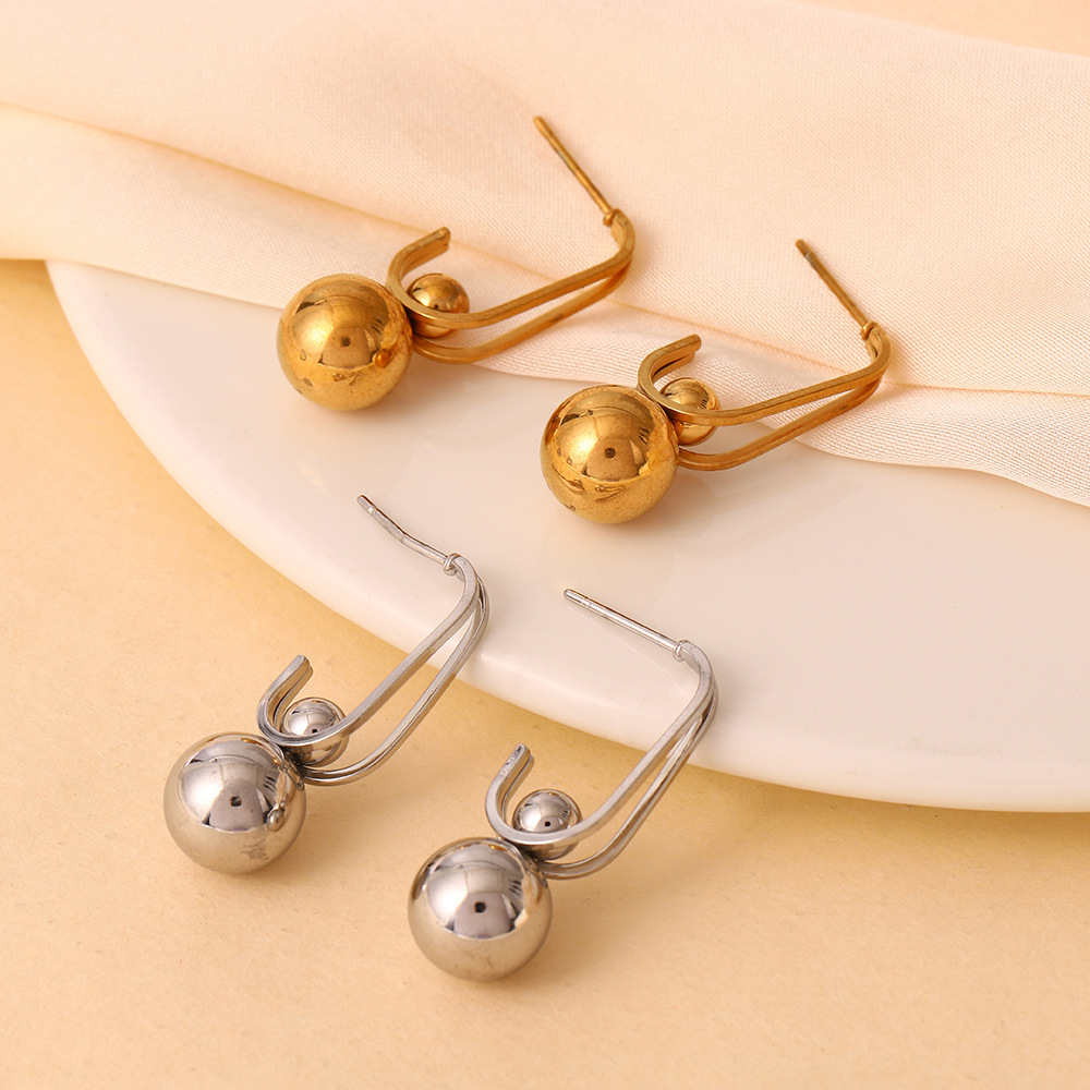 Nueva personalidad europea y americana, diseño de nicho, colgante de cuentas redondas de acero de titanio, pendientes simples irregulares, joyería femenina que no se desvanece