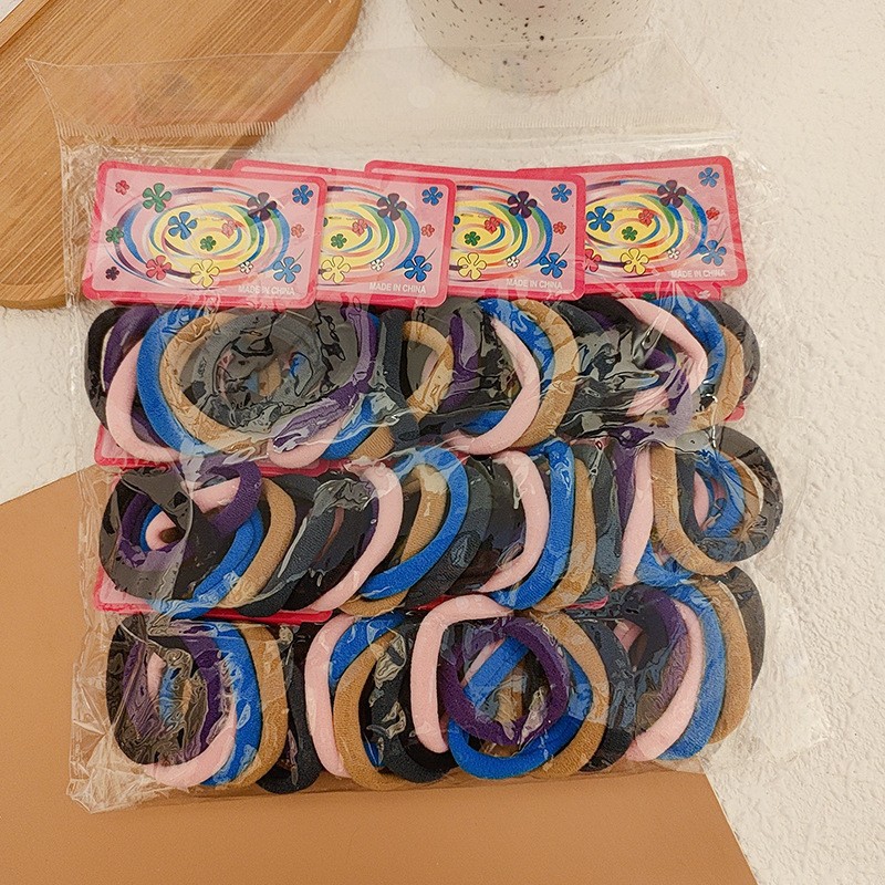 100-pieza de alta elástica sin costura toalla anillo de color Banda de pelo cuerda de pelo de color caramelo banda de goma cubierta de cuero cuerda de pelo al por mayor