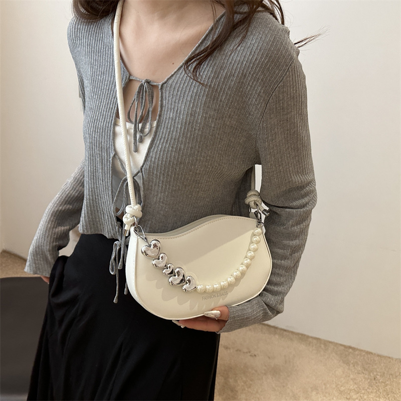 Tendencia de este año 2024 nueva tendencia de perla de viaje de hombro simple moda europea y americana bolso de mano para mujeres