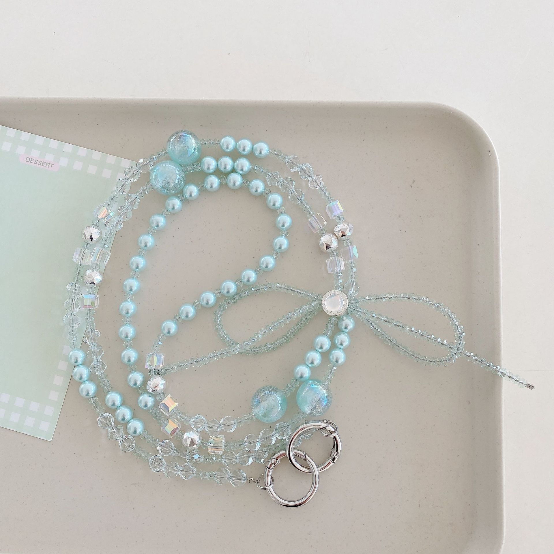 Boutique hecho a mano cadena colgante de alta gama arco fresco de cuatro colores cadena larga cordón de teléfono móvil de moda mensajero largo/colgante