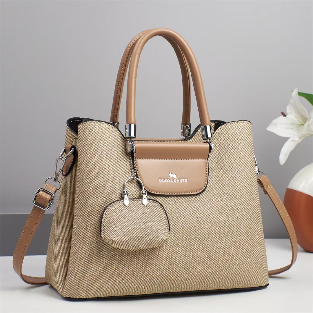 El nuevo bolso de mano para niños y madres está de moda en el bolso de hombro de textura, bolso de mensajero de diseño de nicho coreano de todo fósforo, comercio exterior