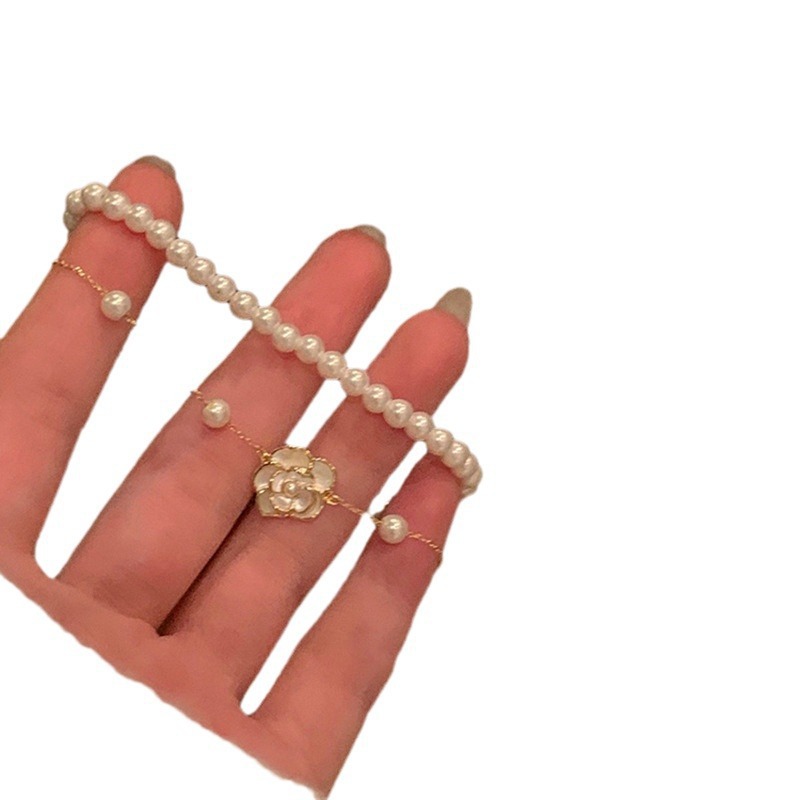 Pulsera de camelia de perlas de doble capa Pulsera ligera de lujo de alta gama, temperamento elegante y versátil, joyería de nicho de moda al por mayor
