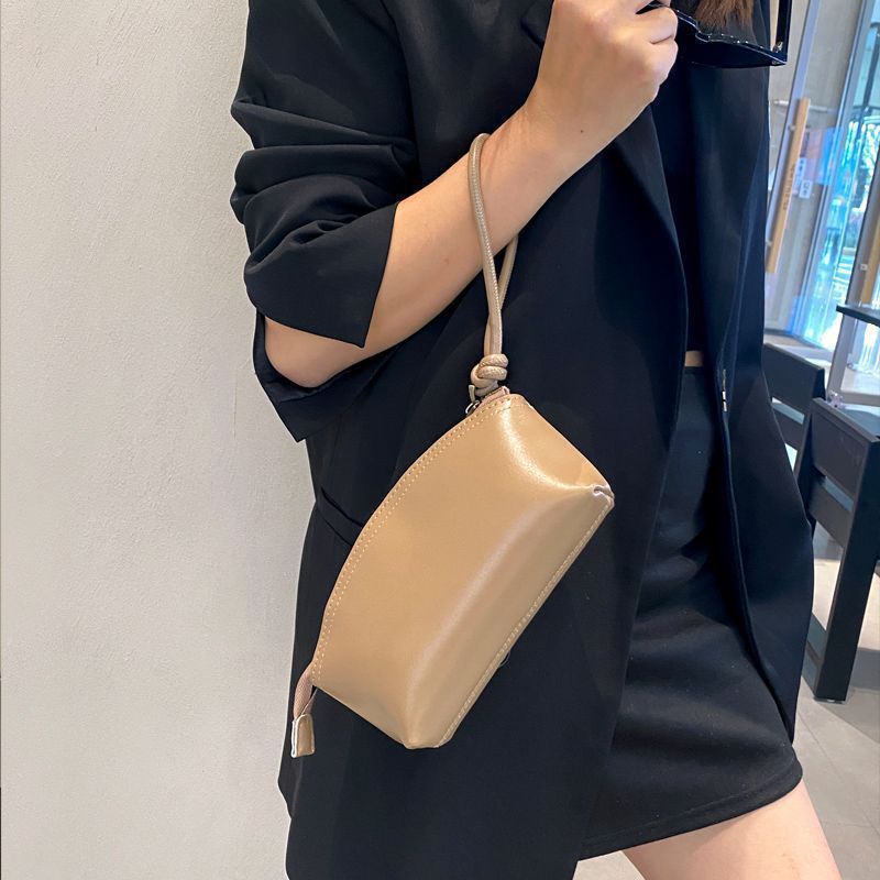 Viajes de moda primavera y verano nuevo nicho de diseño pu piel retrógrada elegante portátil bolso de bollo de gran capacidad transfronterizo para mujeres