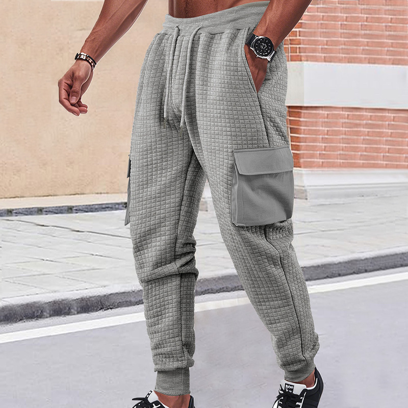 Nuevos pantalones deportivos de hombre de otoño transfronterizos europeos y estadounidenses gruesos pequeños cuadrados herramientas deportivas casuales pantalones de pila