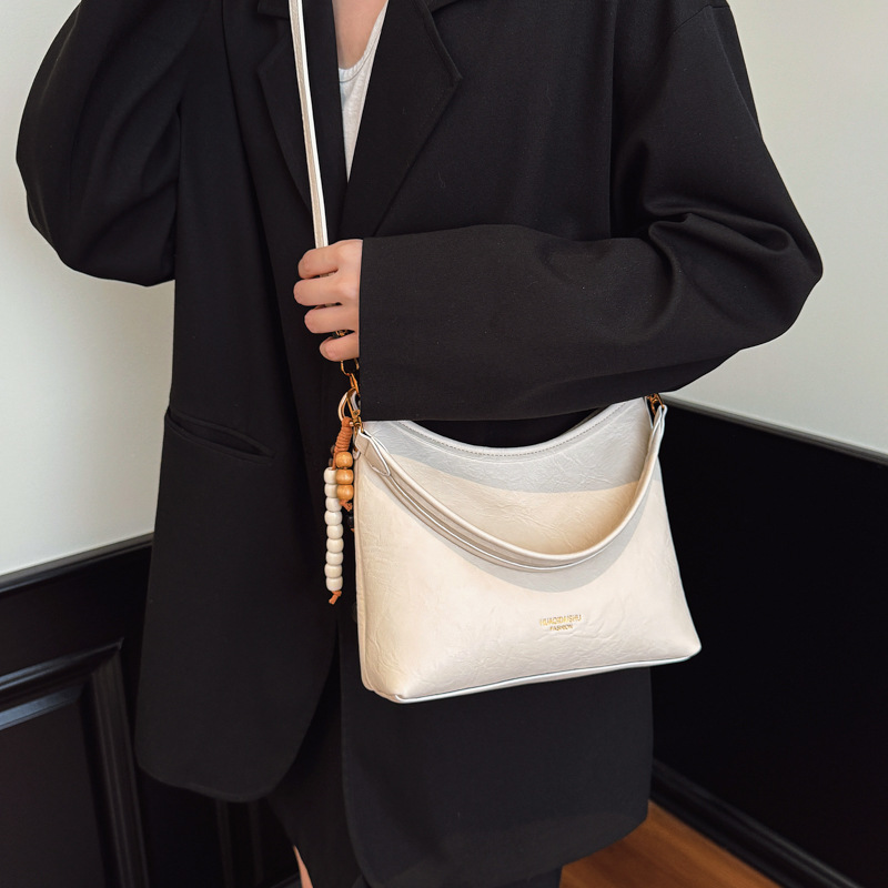 Nicho de alta sensación bolso de cuero suave para mujeres 2025 nueva moda versátil mochila de hombro mochila de viaje