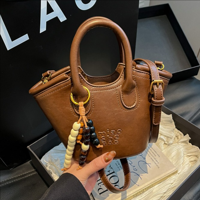 Bolsa de aire coreana para mujeres 2025, otoño y invierno, nuevo estilo de alta calidad, bolso de cubo portátil, bolso de hombro para viajar.