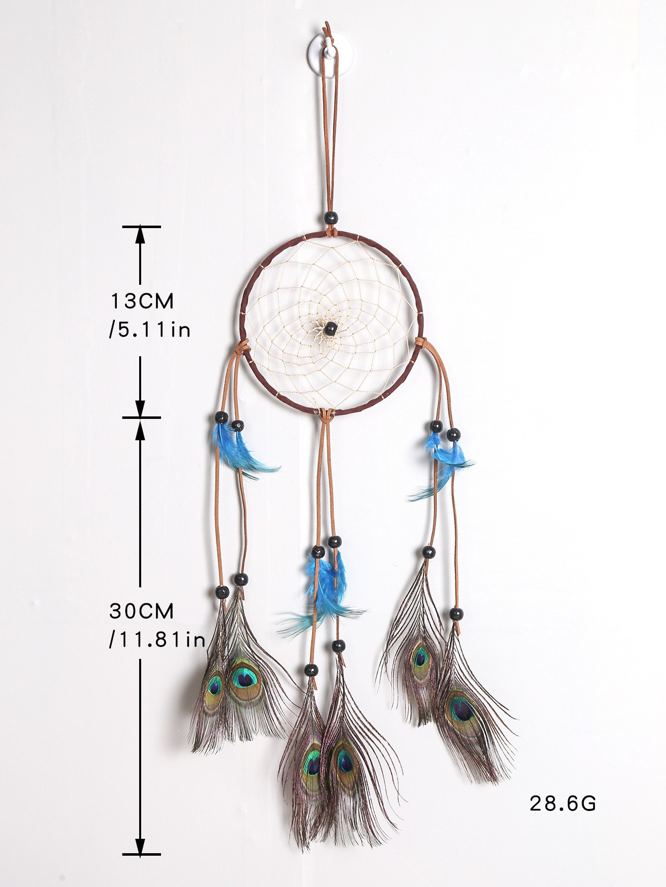 New minimalist handmade peacock feather dreamcatcher with Indian-style wind chime, hanging in the air as home decor, vintage style