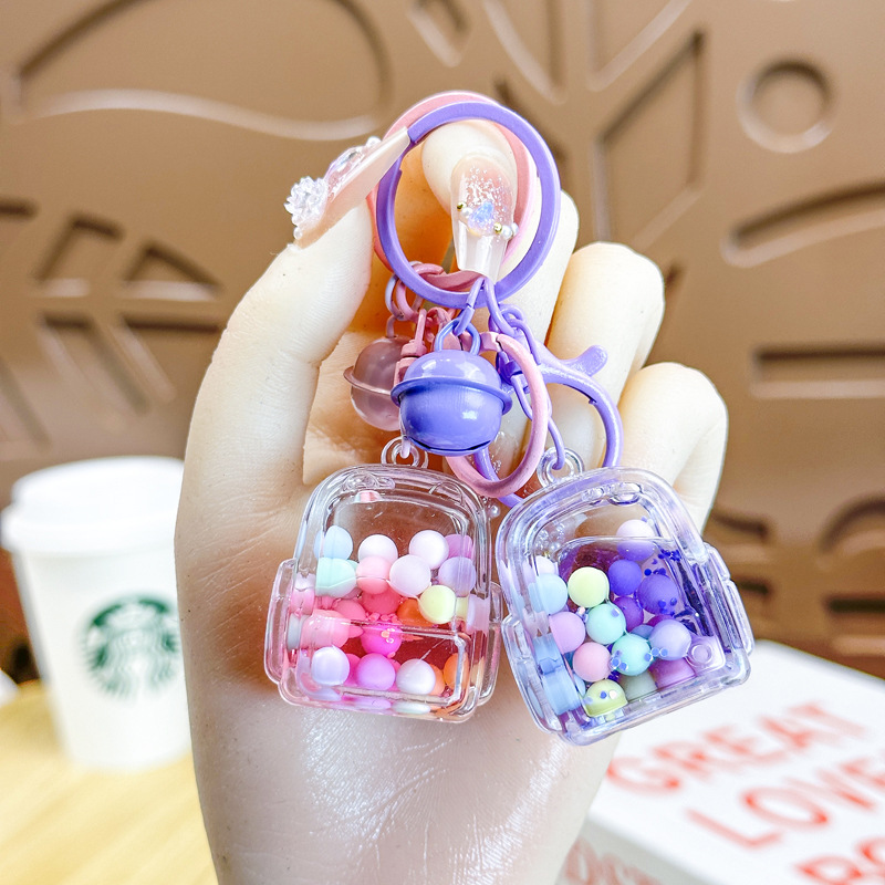 Caricatura en aceite líquido arena flotante botella mochila llavero delicado colgante accesorios accesorios máquina de muñecas pequeños regalos al por mayor