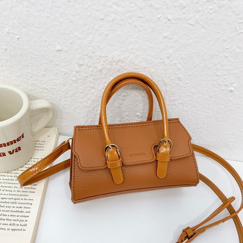 2025 nuevo bolso para niños de comercio exterior, bolso de niña popular de moda coreana, bolso de mensajero para bebé de color sólido de estilo extranjero