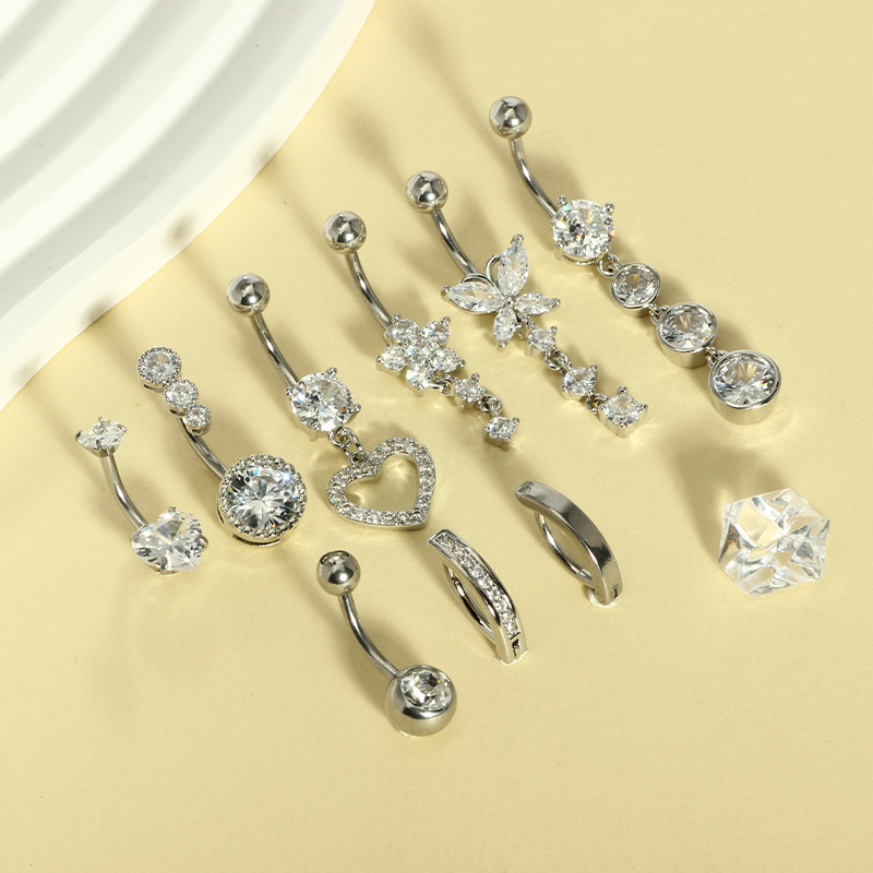 9つのステンレスのへその輪の組み合わせの銅はジルコンの水滴のへその輪の円形のハート型のへその釘のメーカーの現物を入れます。