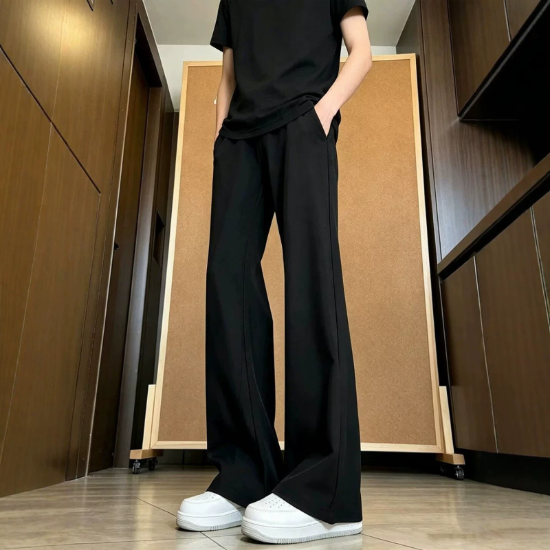 Black, slightly flared, casual trousers for men, straight-leg, slimming, versatile, trendy, and figure-flattering, with a curved hem Black, slightly flared, casual trousers for men, straight-leg, slimming, versatile, trendy, and figure-flattering, with a curved hem