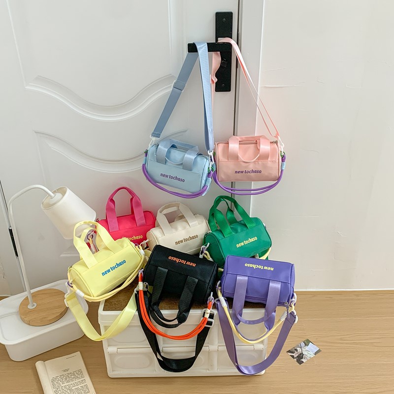 Bolsa de hombro casuales coreana para niños y niñas, letras extranjeras para bebés, bolsas portátiles de balde de agua 2025, nuevas bolsas de comercio exterior para niños