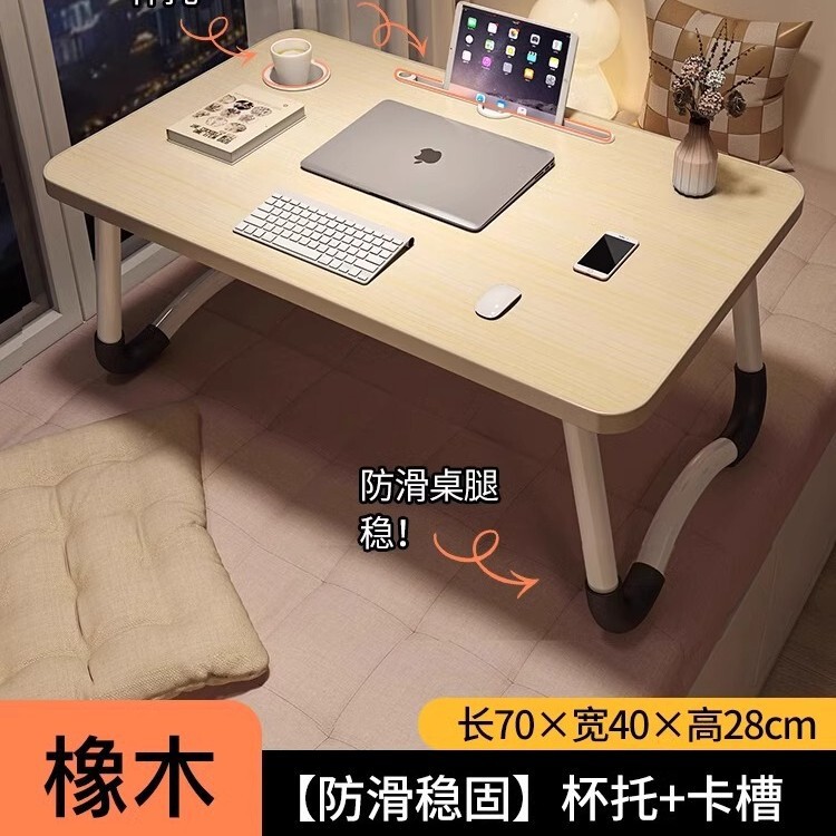 折り畳み可能なベッドの上の小さなテーブルは机のノートパソコンのテーブルを勉強します。|undefined