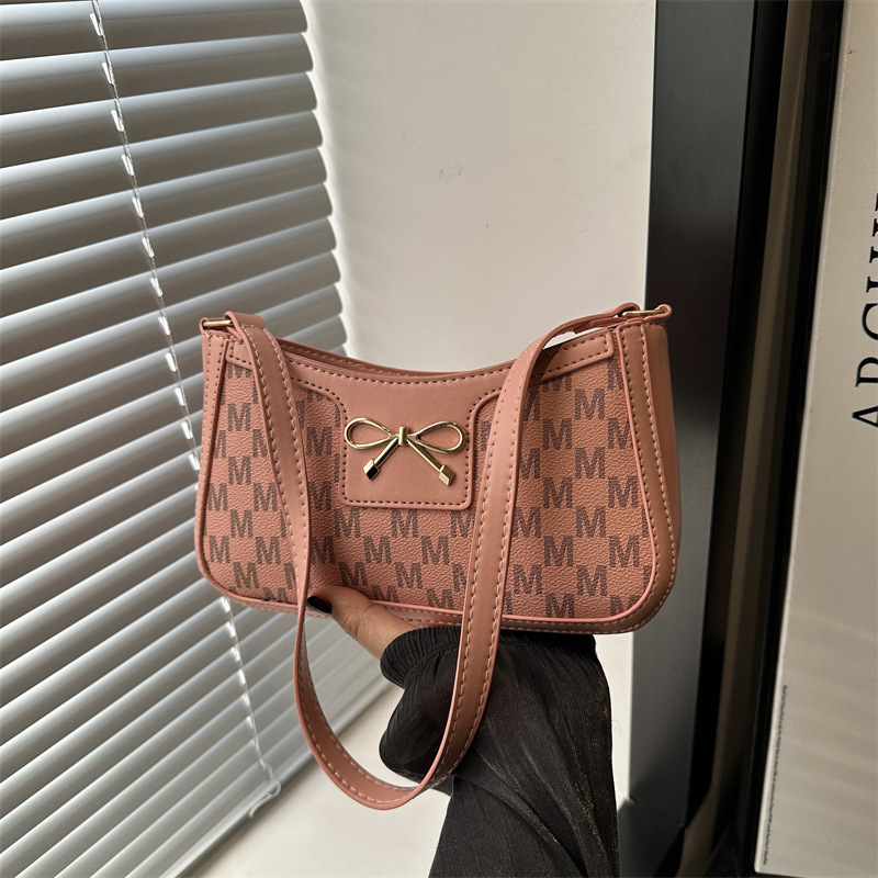 Cosmetía coreana estilo de moda textura arco de moda primavera 2025 nuevo estilo extranjero de viaje brazo bolso de hombro para mujeres