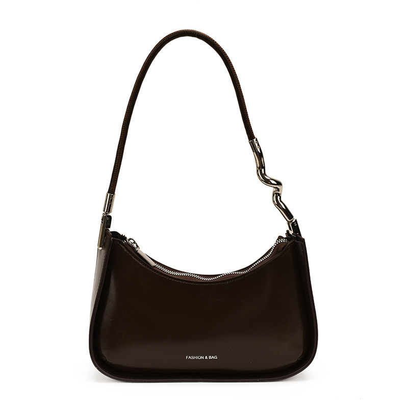 Nicho de diseño bolso de brazo para mujeres 2026 comercio exterior nueva moda alta sensación de viaje simple bolso de media luna de hombro