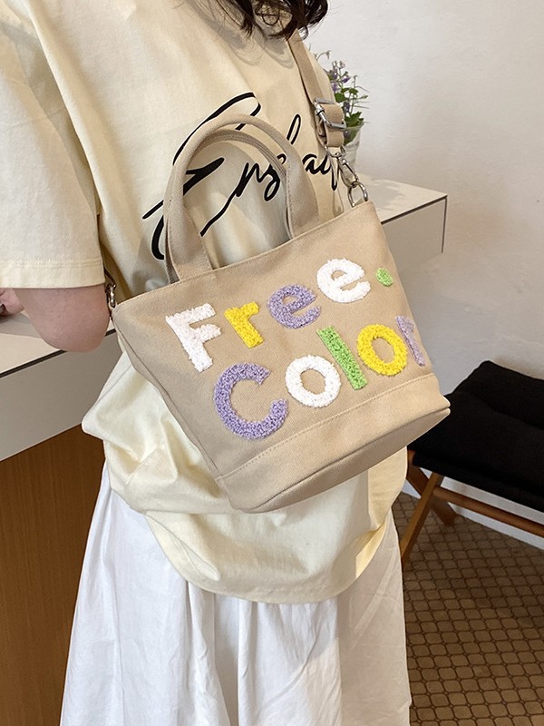 Mamá bolso para salir bolso de cubo de mano mujer 2026 nuevo bolso de lona bordado de dibujos animados letras casuales bolso de mochila