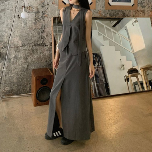 A vintage-style suit set with a sleeveless gray waistcoat for women, featuring a half-body skirt with slits for summer, exuding a sense of elegance - a two-piece set.