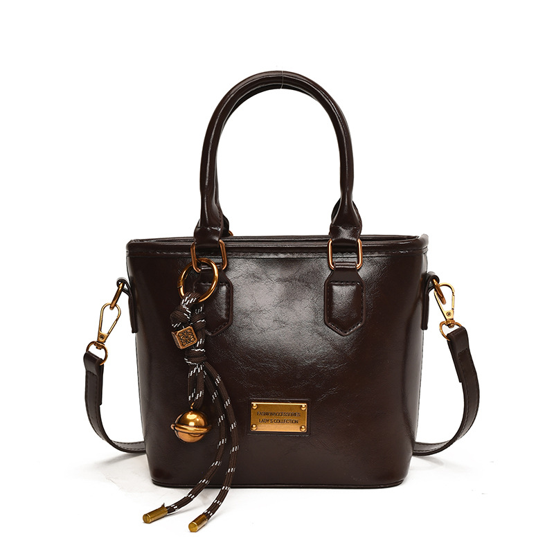 Retro versátil simple bolso de cubo portátil 2025 nuevo bolso de mujer nicho manuscrito de moda coreana bolso de hombro