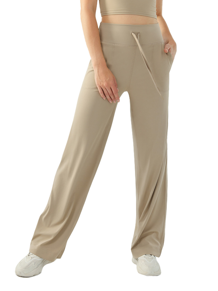 裸感の高い腰のひもの運動のズボンの女性のゆったりしている広脚の純色のフィットネスのズボンのランニングはスリムに見えます。