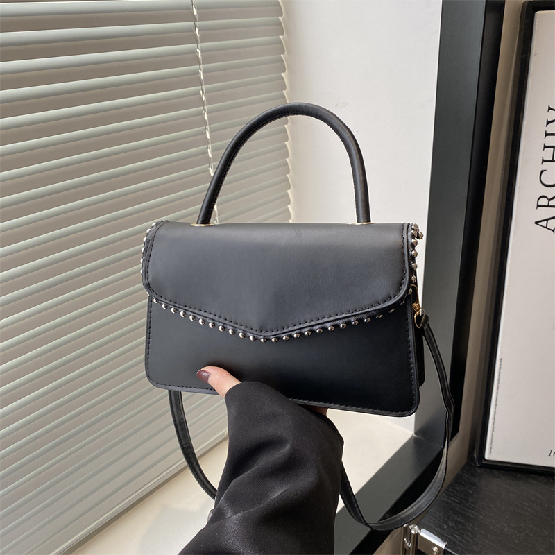 Bolso de hombro de aire extranjero para mujeres 2025 primavera nueva moda coreana portátil de color sólido simple bolso de tendencia