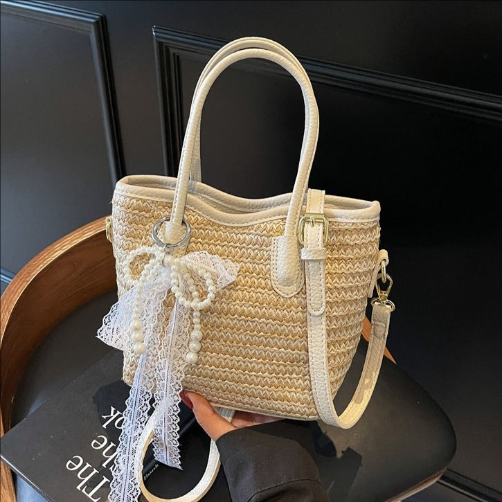 Bolso de cubo portátil de paja de gran capacidad de tendencia para mujer 2025 nuevo bolso de mensajero de hombro de moda de viaje de vacaciones en la playa