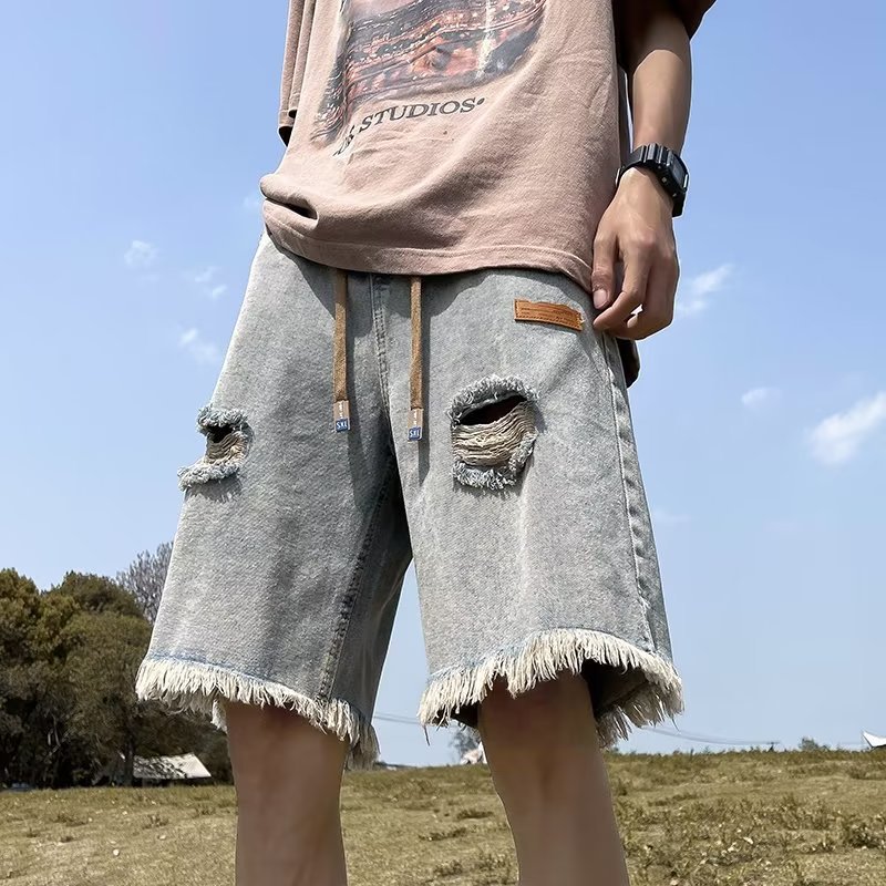 Pantalones cortos de mezclilla rasgados con bordes sin rebabas para hombre American High Street retro verano delgado casual tendencia guapos pantalones de cinco puntos