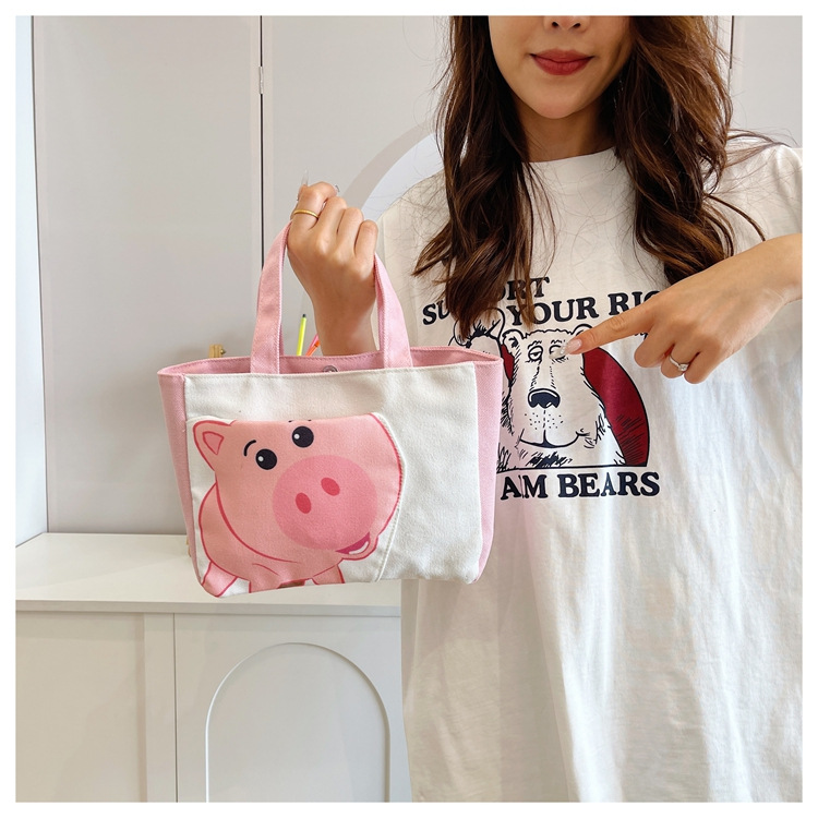 Cute cartoon printed small bag, 2024 summer new style hand-held piggy girl handbag, student storage canvas bag Item Picture