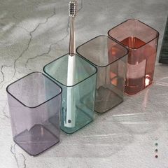 家庭用の透明なプラスチックのコップの洋風は簡単です。カップルは歯を磨くコップを使います。