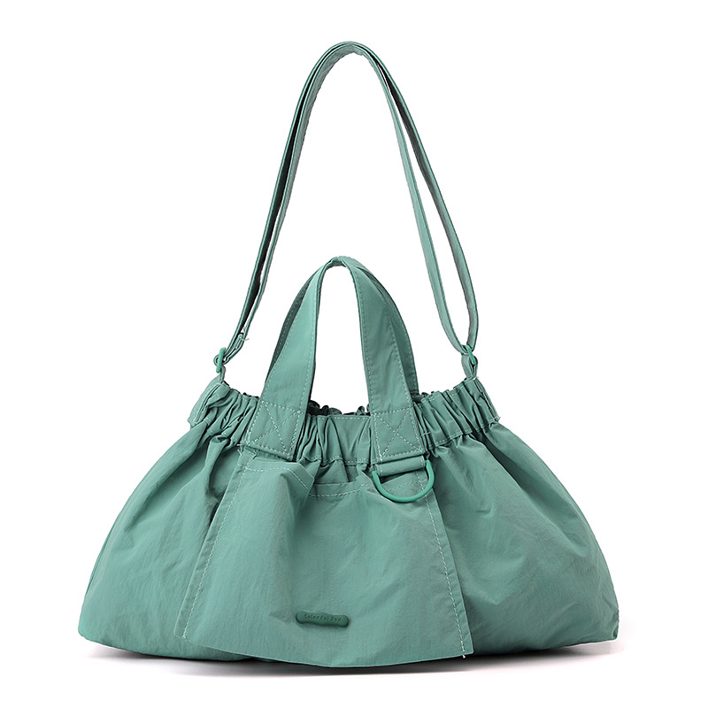 El nuevo diseño de nicho coreano del comercio exterior tiene un sentido del conocimiento de embarque a mano y una bolsa de mujer en el hombro es ligera, casual y plegable.