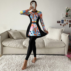 Muslim swimwear with random graphic prints: conservative, full-coverage three-piece set featuring long-sleeve one-piece tops and long pants with shorts.