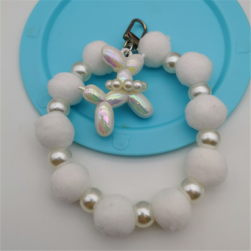 Nueva bola de piel de cadena de perlas colgante cadena de teléfono móvil ins Internet celebridad mismo estilo muñeca de invierno pulsera peluda cadena portátil