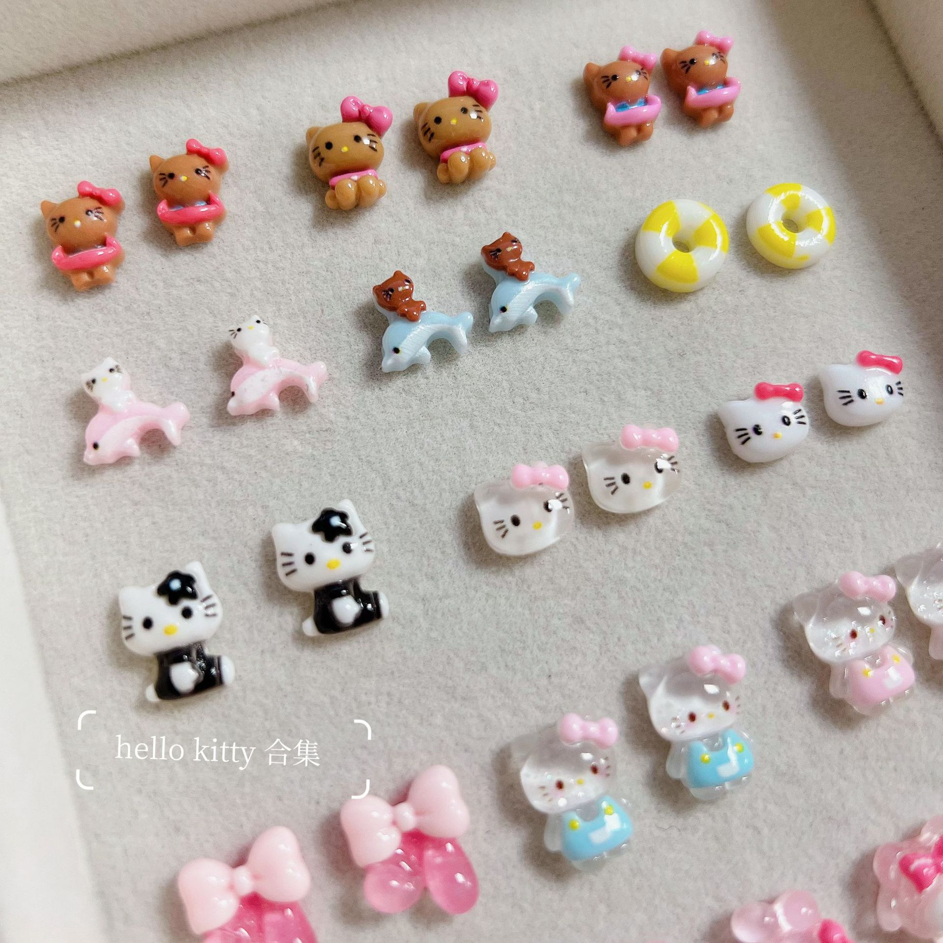 新商品のキティキャットの三麗鴎のネイルアクセサリーのネットの赤い爆発の樹脂のかわいいkt猫は甲を着て飾ります。