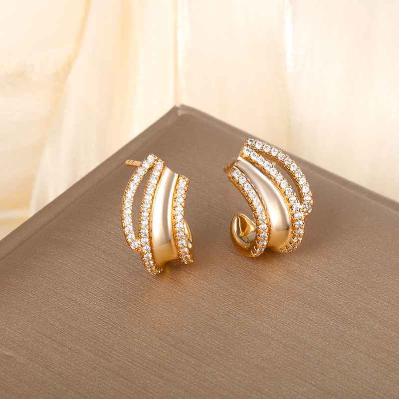 Pendientes de circonio chapados en oro de aleación de joyería Xuping, estilo coreano, sentido de diseño exquisito y compacto, pendiente de nicho europeo y americano