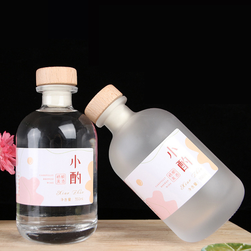 Botella de vidrio esmerilado transparente al por mayor botella de vino de fruta casera de cerveza botella de vino vacía botella de vodka botella de vino de ciruela cubierta de madera