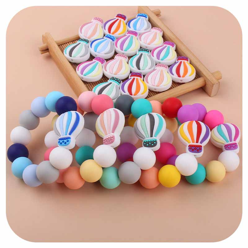Nuevo bebé dibujos animados globo de aire caliente pulsera de silicona teether palo pezón cadena anti-gota cadena juguete teether