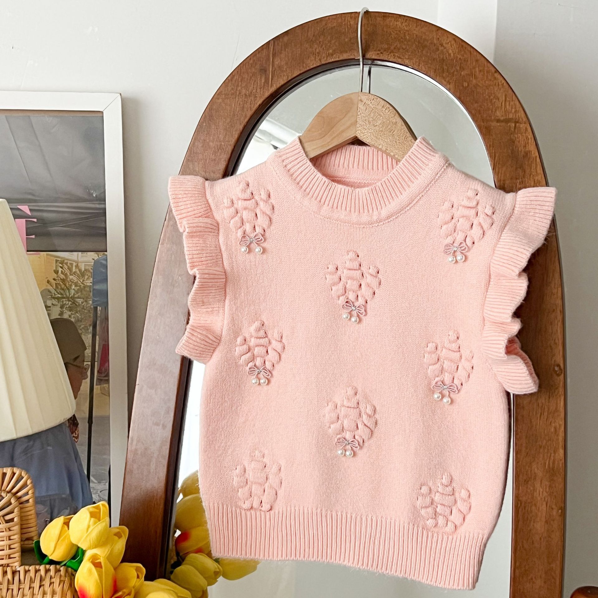 Niñas 2025 otoño y invierno nuevo chaleco de punto coreano estilo extranjero bebé de cuello redondo de color sólido arco chaleco de punto