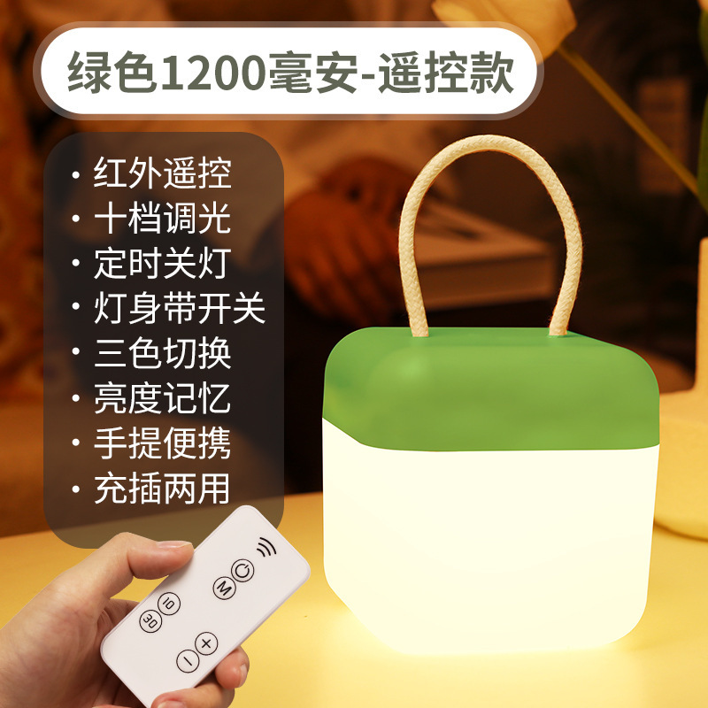 明かりをつけてベッドの上でリモコンの小さい夜の明かりで室内の壁の学生の寮の明かりを掛けます。|undefined