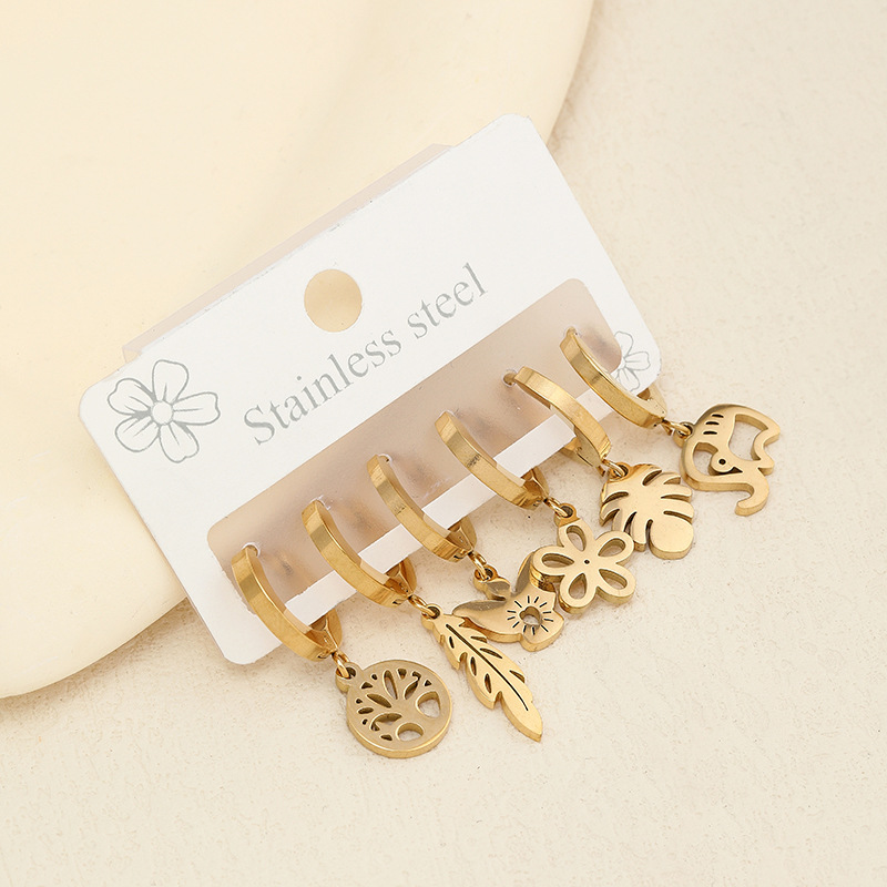 Joyería de acero inoxidable transfronterizo corte hueco flor planta Awn estrella patrón geométrico oreja dorada hebilla traje fabricante