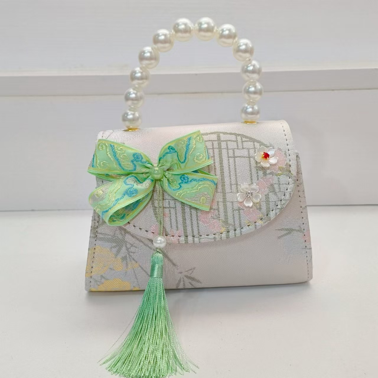 Bolsas de niños arco de estilo chino borda de niña pequeña princesa perla bolsa de cambio de mano al por mayor